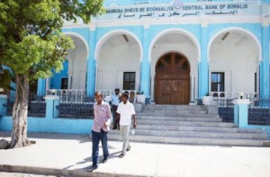 People outside Somalia’s central Bank in Hamarwayne district, south of Mogadishu. The well-thumbed and ragged notes of the Somali shilling are in short supply because they were last printed before 1991.